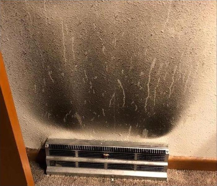 A soot covered wall from a vent