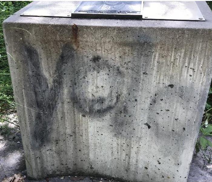 A stone memorial with spray paint