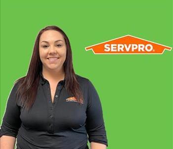 Girl in front of SERVPRO green with logo