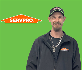 a man in front of a servpro background 